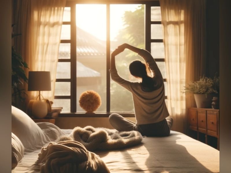 pessoa fazendo alongamento pela manhã ao lado da cama - manter hábitos saudáveis